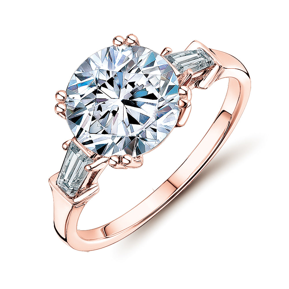 Round Brilliant and Baguette shouldered engagement ring with 3.17 carats* of diamond simulants in 10 carat rose gold
