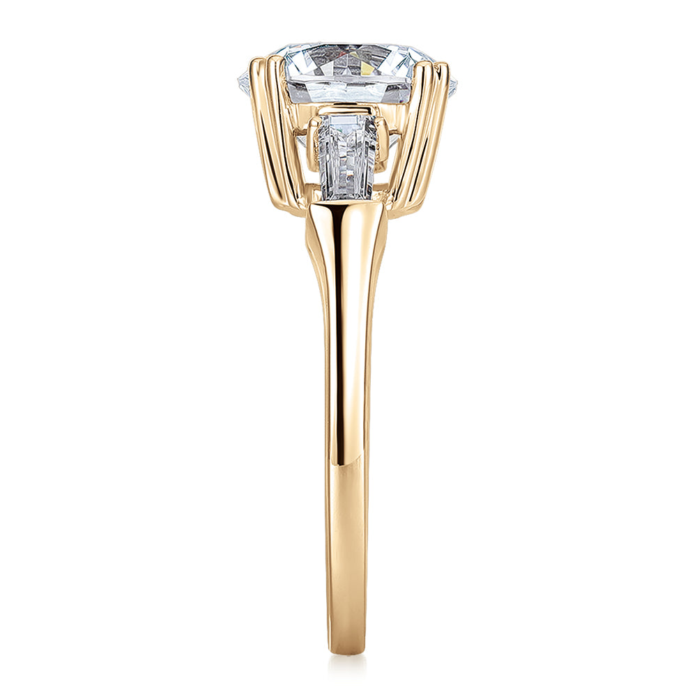 Round Brilliant and Baguette shouldered engagement ring with 3.17 carats* of diamond simulants in 10 carat yellow gold