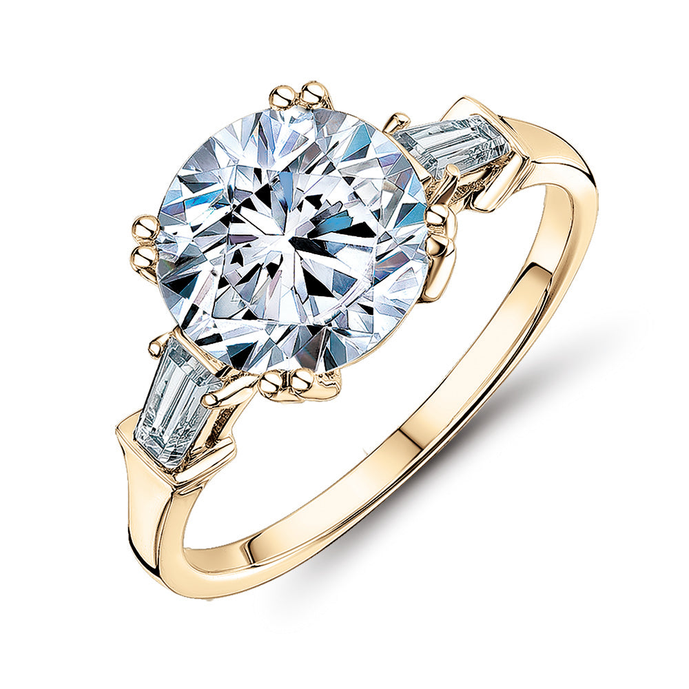 Round Brilliant and Baguette shouldered engagement ring with 3.17 carats* of diamond simulants in 10 carat yellow gold