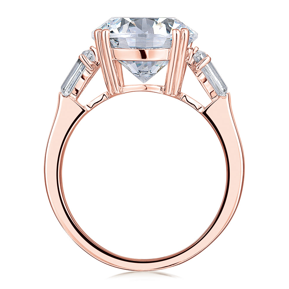 Round Brilliant and Baguette shouldered engagement ring with 5.33 carats* of diamond simulants in 10 carat rose gold