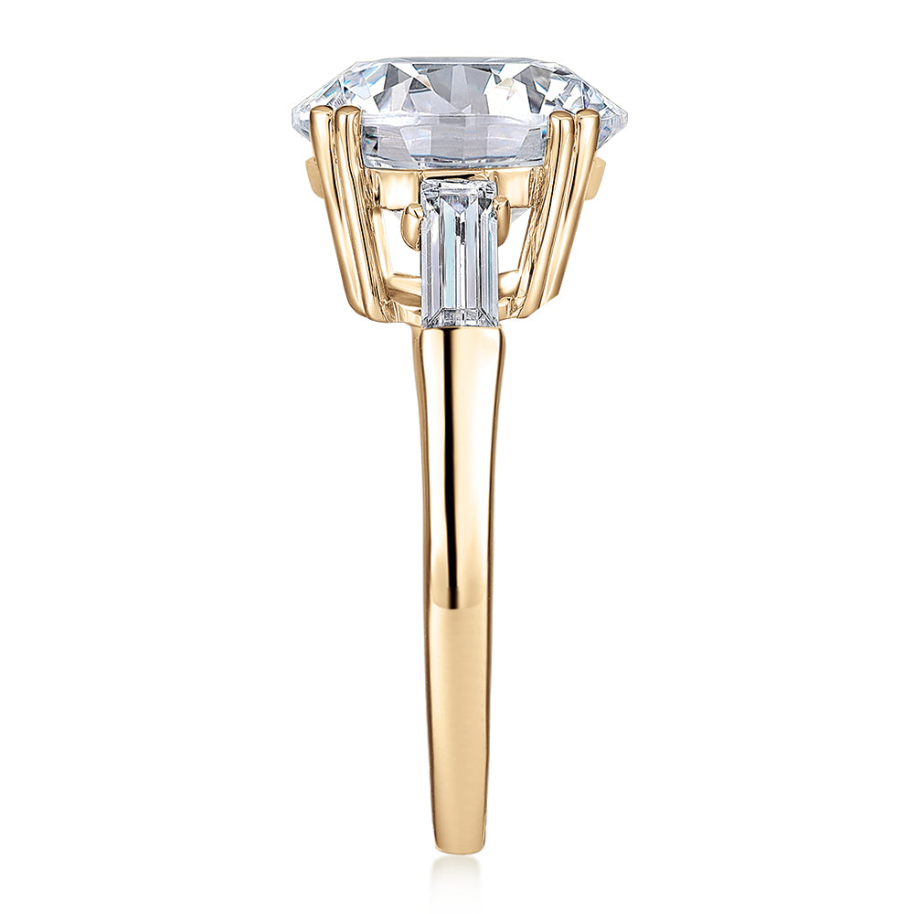 Round Brilliant and Baguette shouldered engagement ring with 5.33 carats* of diamond simulants in 10 carat yellow gold