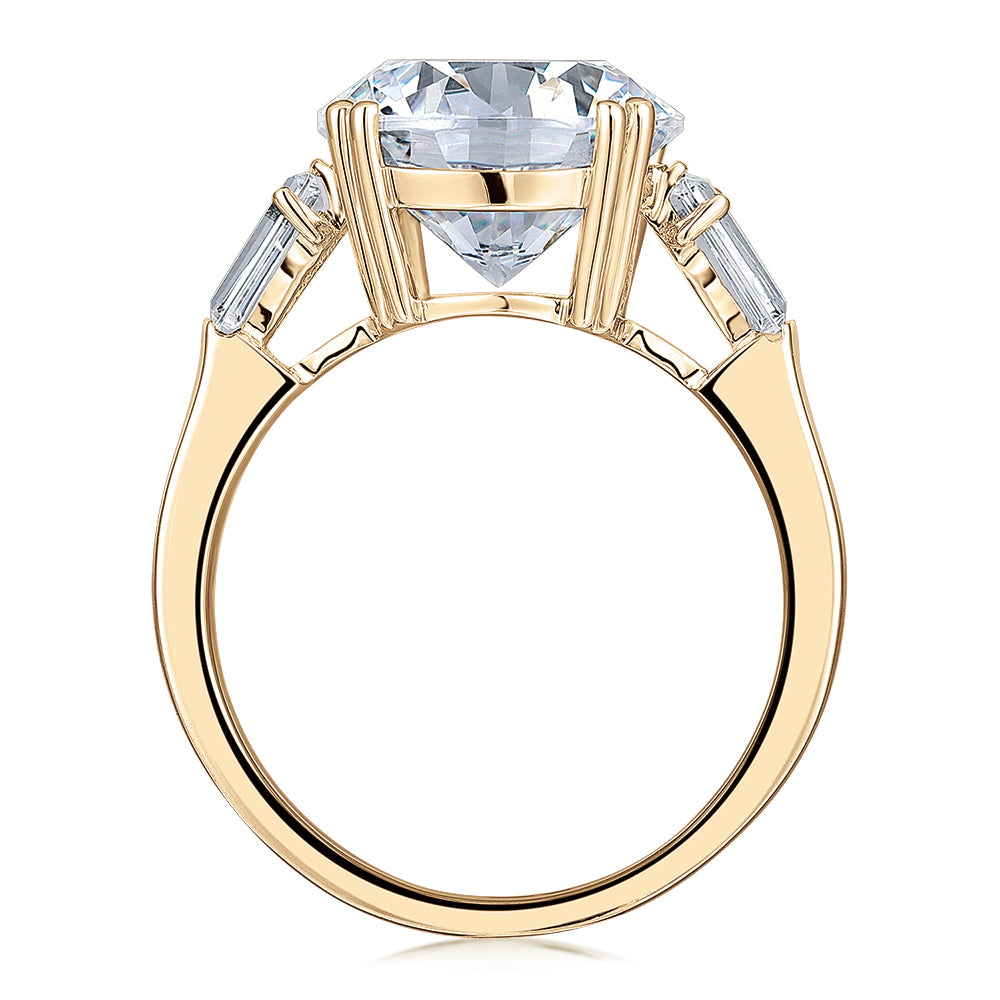 Round Brilliant and Baguette shouldered engagement ring with 5.33 carats* of diamond simulants in 10 carat yellow gold