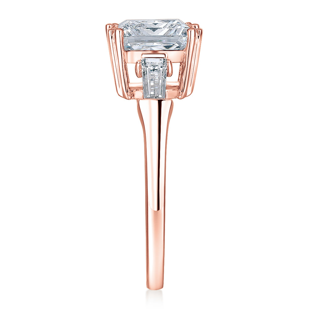 Princess Cut and Baguette shouldered engagement ring with 3.43 carats* of diamond simulants in 10 carat rose gold