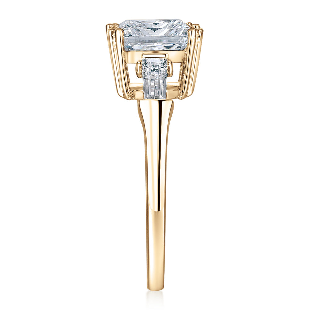 Princess Cut and Baguette shouldered engagement ring with 3.43 carats* of diamond simulants in 10 carat yellow gold