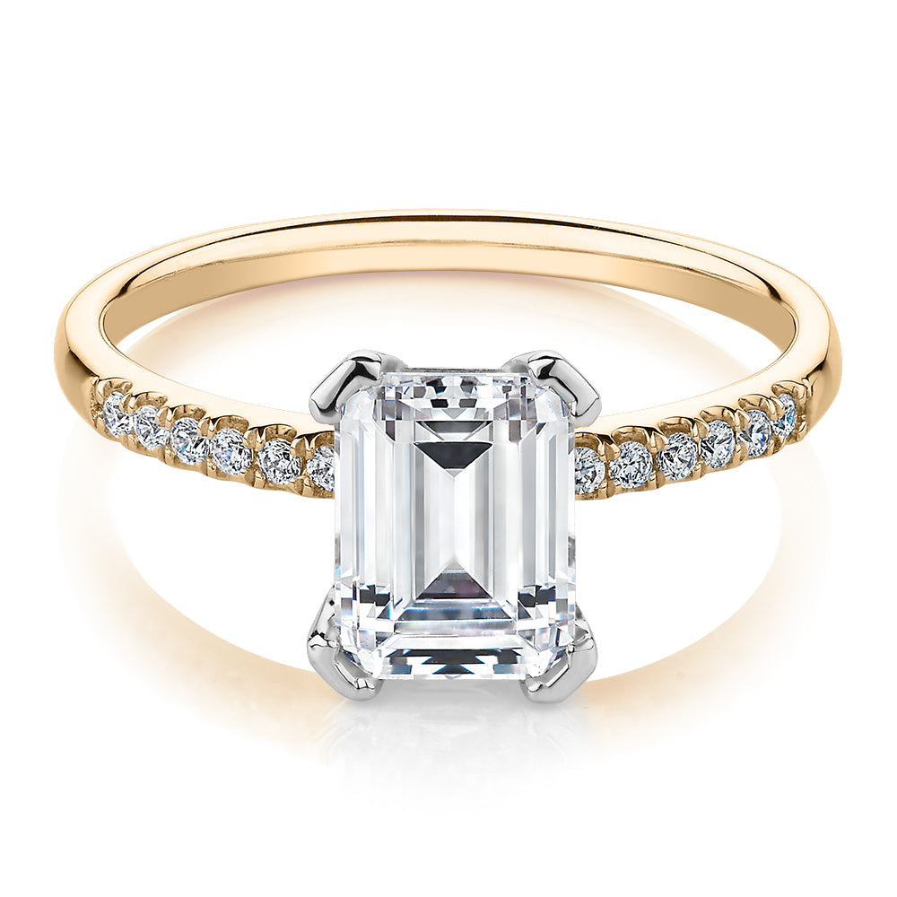 Emerald Cut and Round Brilliant shouldered engagement ring with 1.82 carats* of diamond simulants in 14 carat yellow and white gold