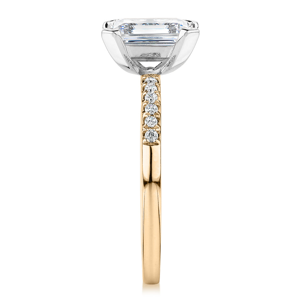 Emerald Cut and Round Brilliant shouldered engagement ring with 1.82 carats* of diamond simulants in 14 carat yellow and white gold