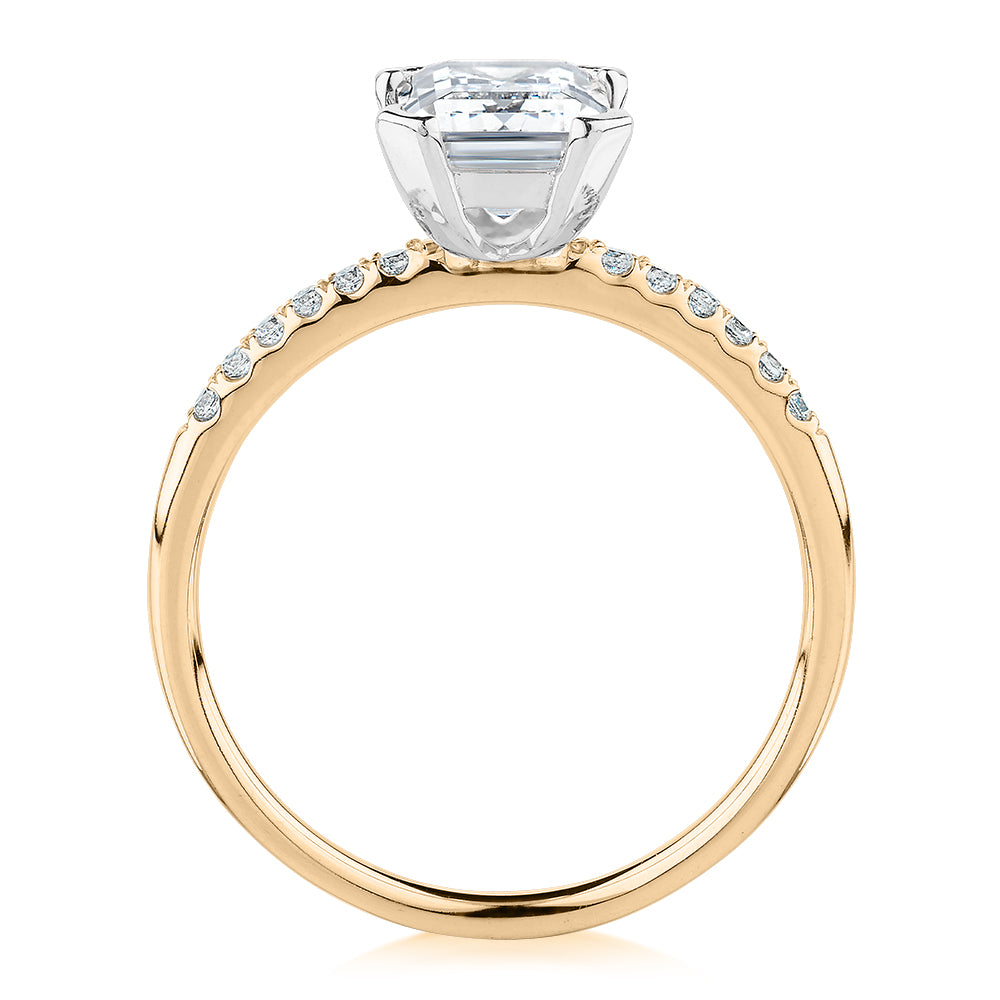 Emerald Cut and Round Brilliant shouldered engagement ring with 1.82 carats* of diamond simulants in 14 carat yellow and white gold