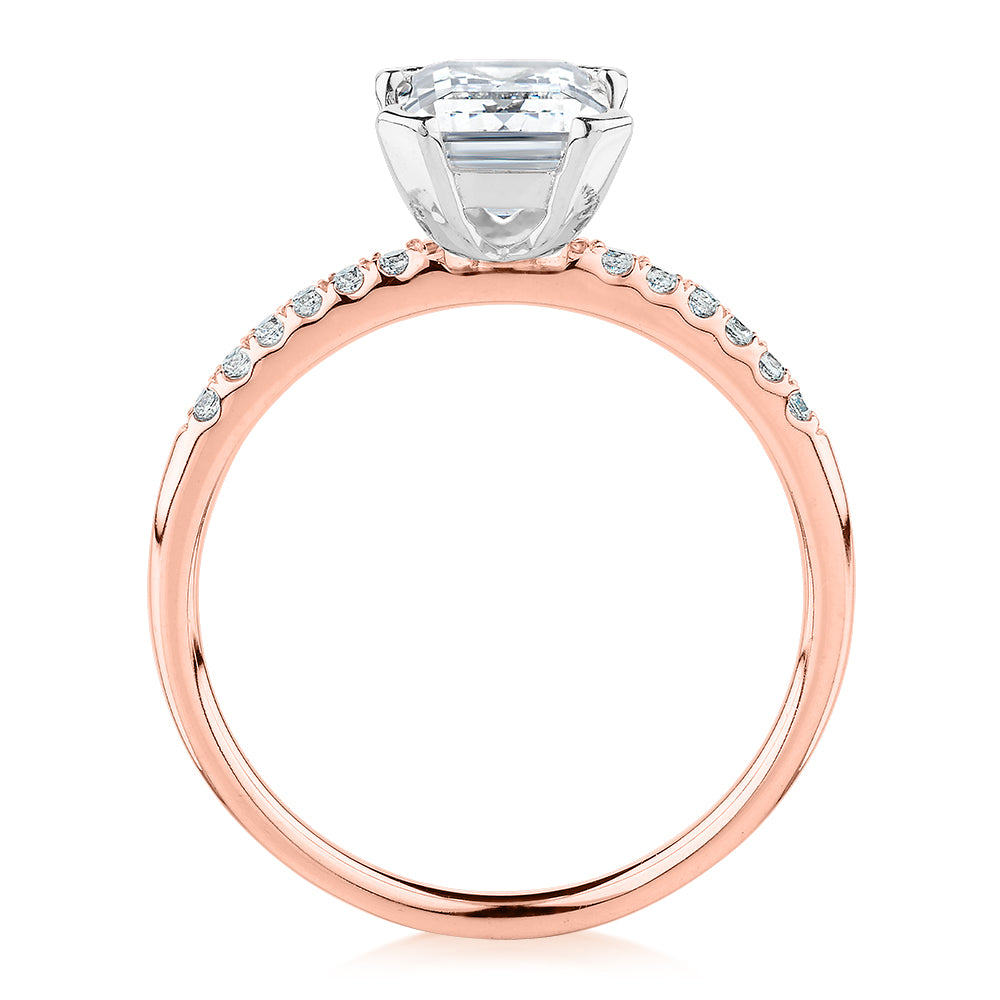 Emerald Cut and Round Brilliant shouldered engagement ring with 1.82 carats* of diamond simulants in 14 carat rose and white gold