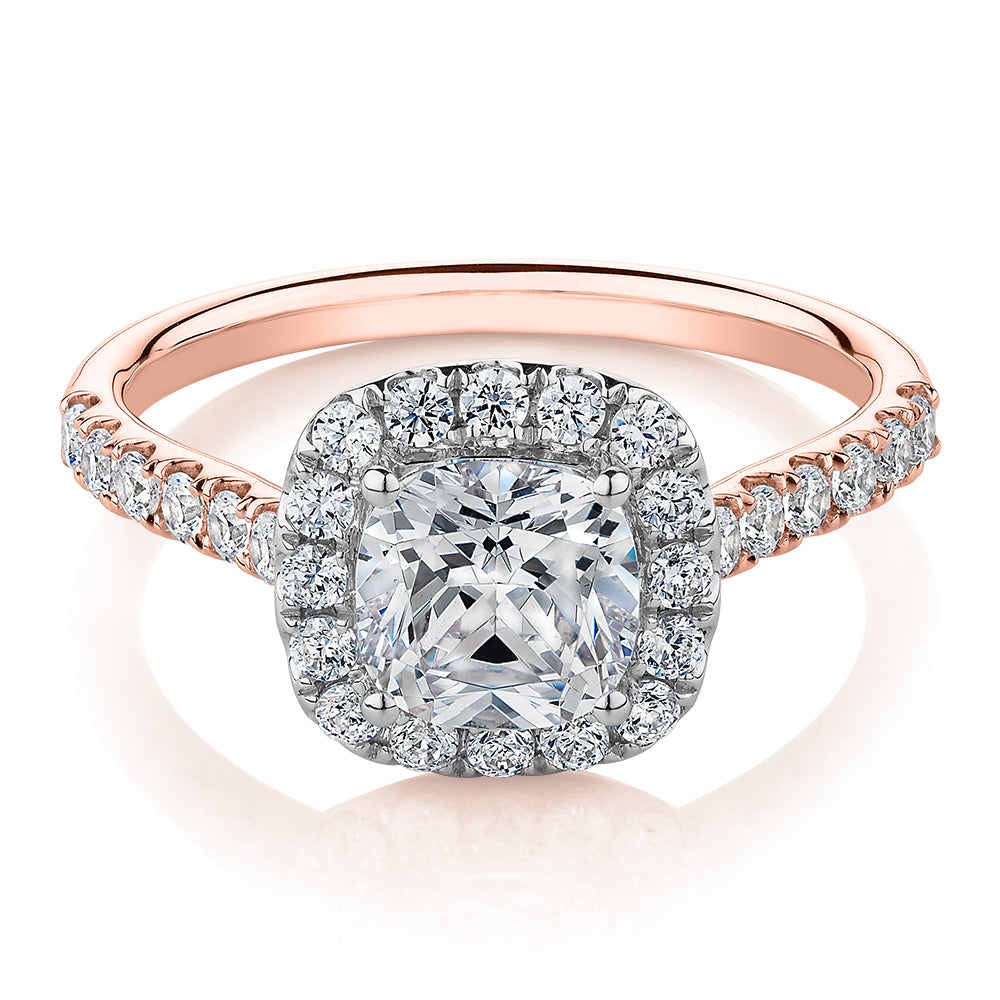 Cushion and Round Brilliant halo engagement ring with 1.65 carats* of diamond simulants in 14 carat rose and white gold