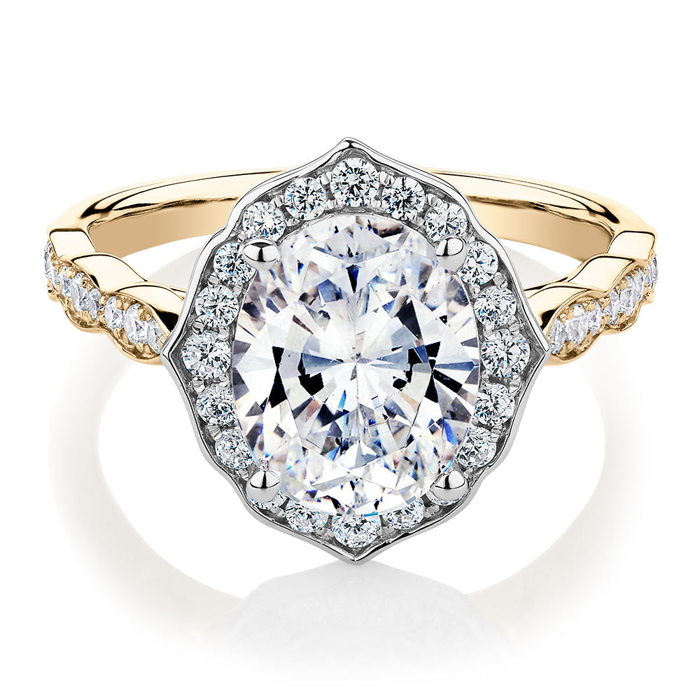 Oval and Round Brilliant halo engagement ring with 2.86 carats* of diamond simulants in 14 carat yellow and white gold