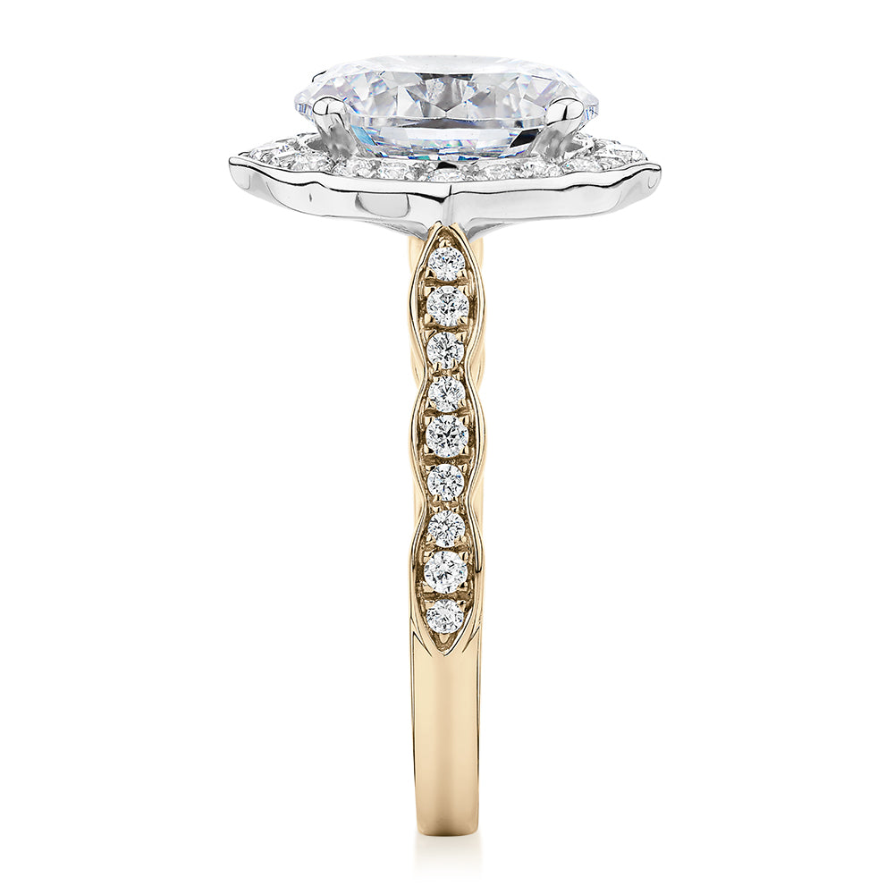 Oval and Round Brilliant halo engagement ring with 2.86 carats* of diamond simulants in 14 carat yellow and white gold