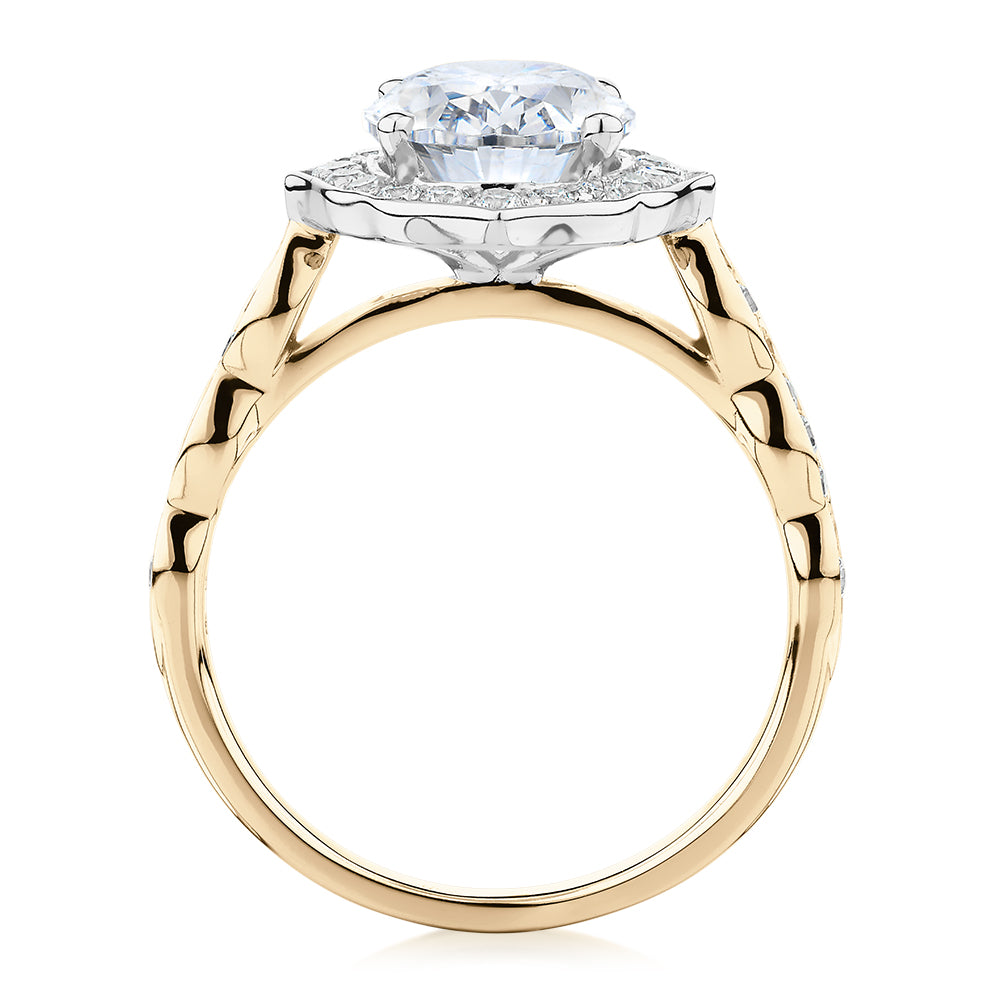 Oval and Round Brilliant halo engagement ring with 2.86 carats* of diamond simulants in 14 carat yellow and white gold