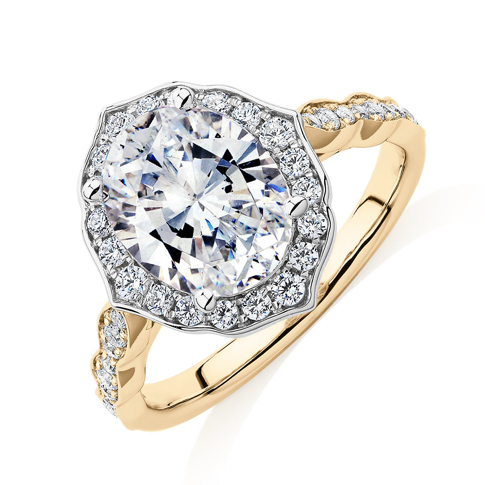 Oval and Round Brilliant halo engagement ring with 2.86 carats* of diamond simulants in 14 carat yellow and white gold