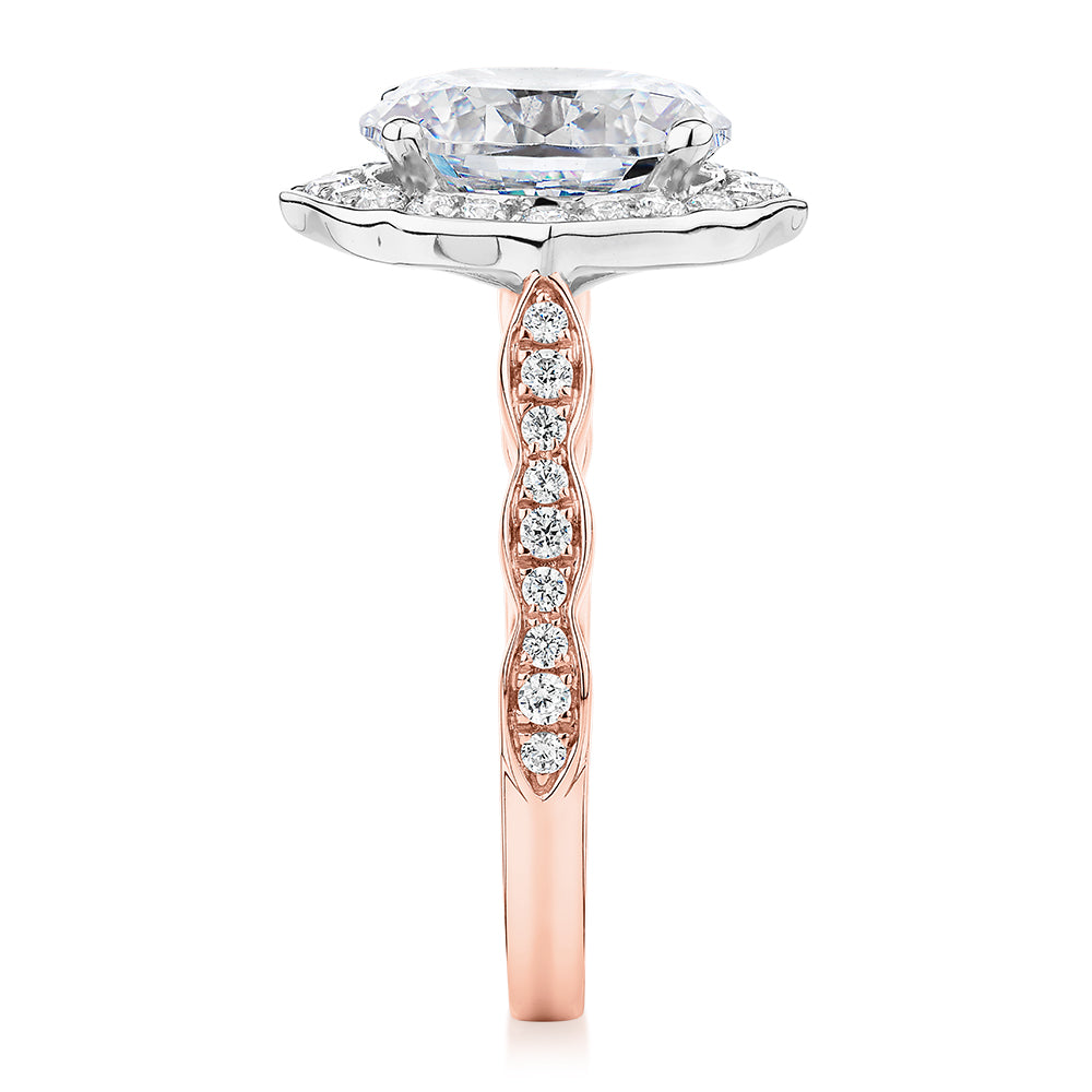Oval and Round Brilliant halo engagement ring with 2.86 carats* of diamond simulants in 14 carat rose and white gold