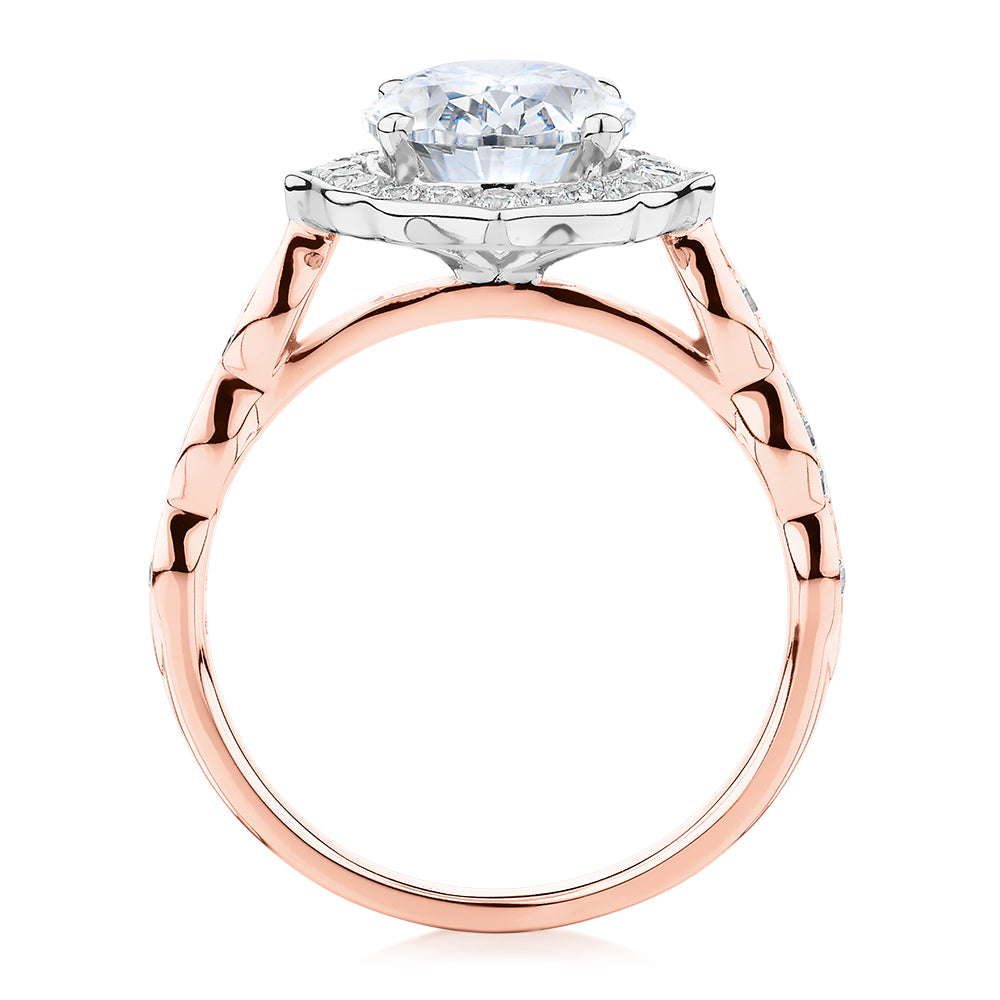 Oval and Round Brilliant halo engagement ring with 2.86 carats* of diamond simulants in 14 carat rose and white gold
