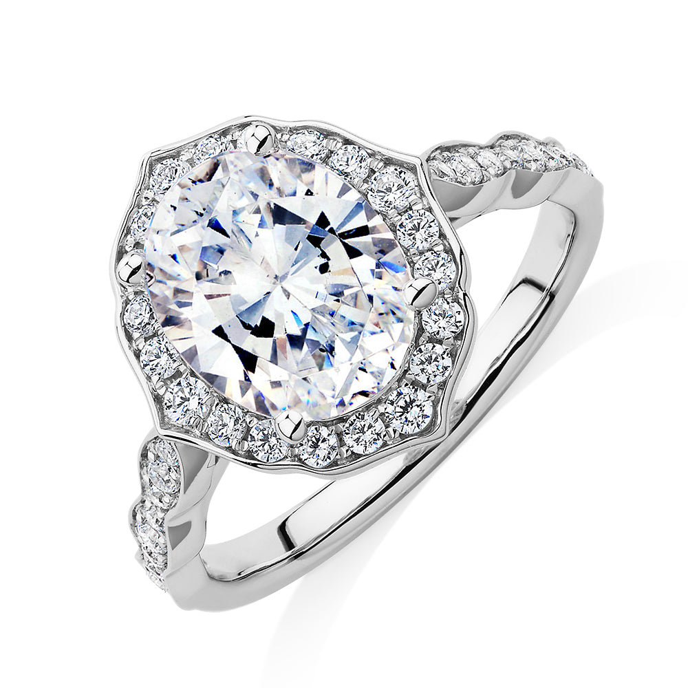 Oval and Round Brilliant halo engagement ring with 2.86 carats* of diamond simulants in 14 carat white gold