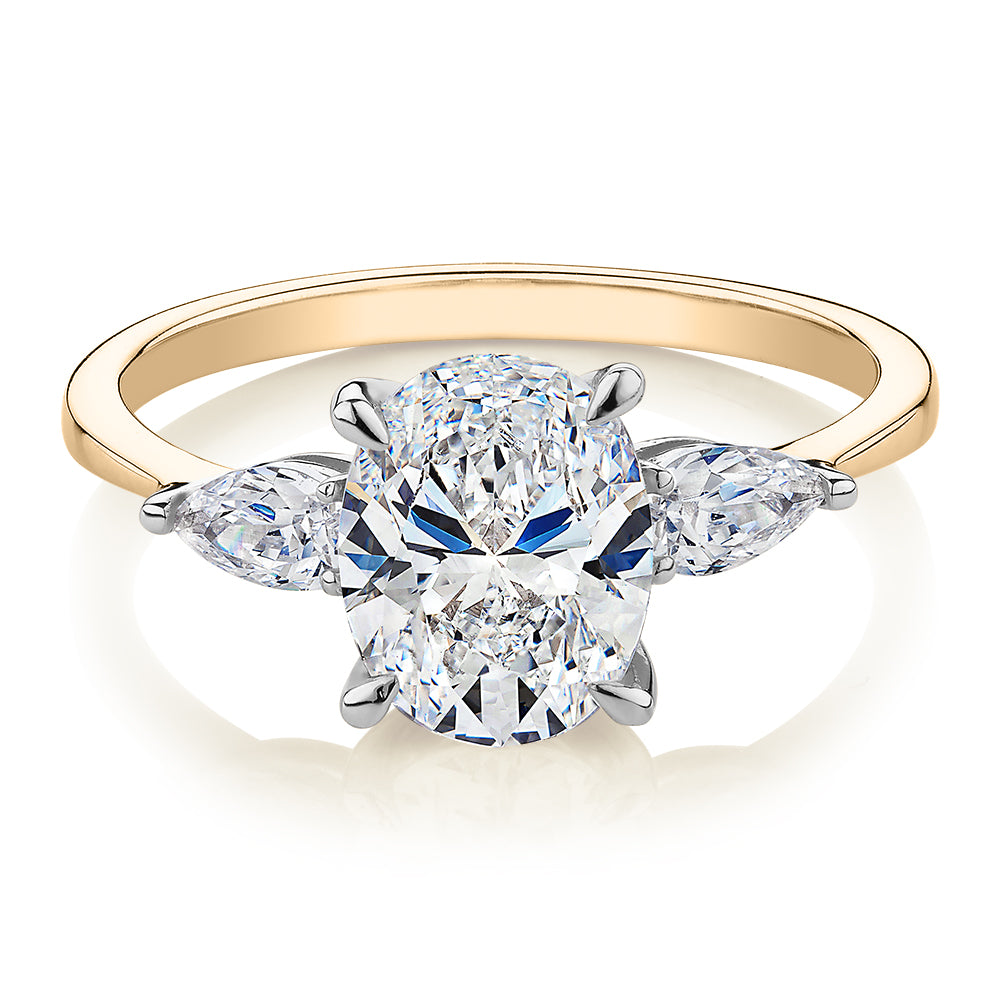 Oval and Pear shouldered engagement ring with 2.36 carats* of diamond simulants in 14 carat yellow and white gold