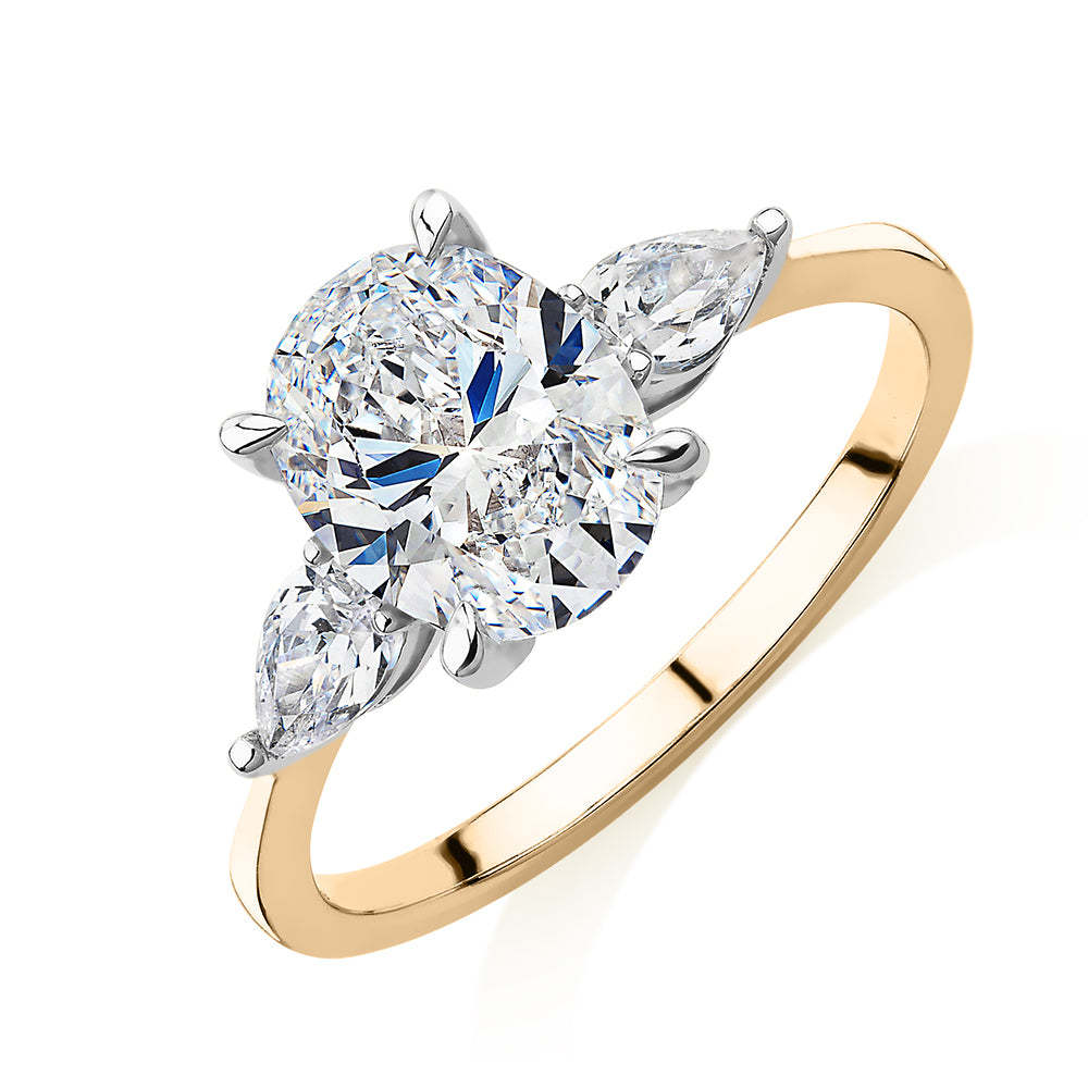 Oval and Pear shouldered engagement ring with 2.36 carats* of diamond simulants in 14 carat yellow and white gold