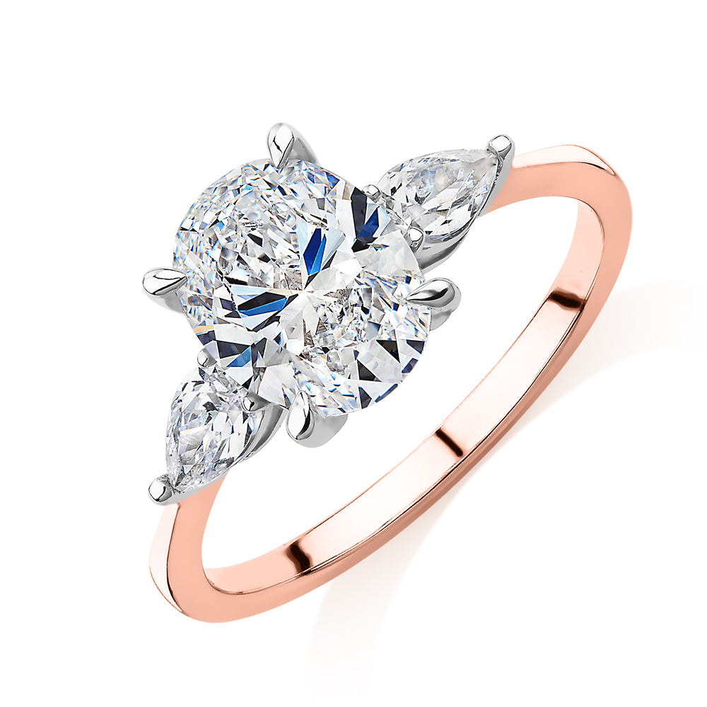 Oval and Pear shouldered engagement ring with 2.36 carats* of diamond simulants in 14 carat rose and white gold