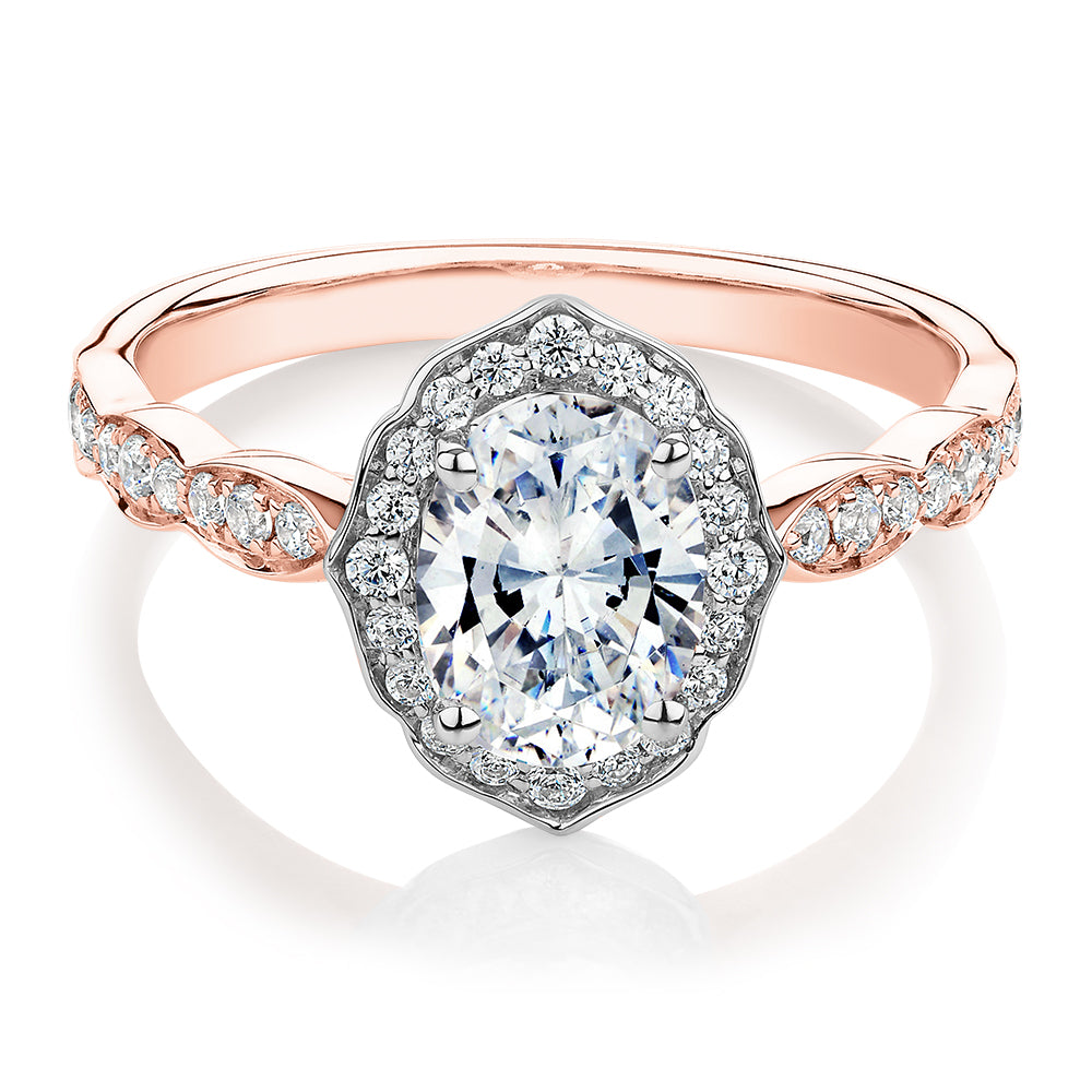 Oval halo engagement ring with 1.55 carats* of diamond simulants in 14 carat rose and white gold