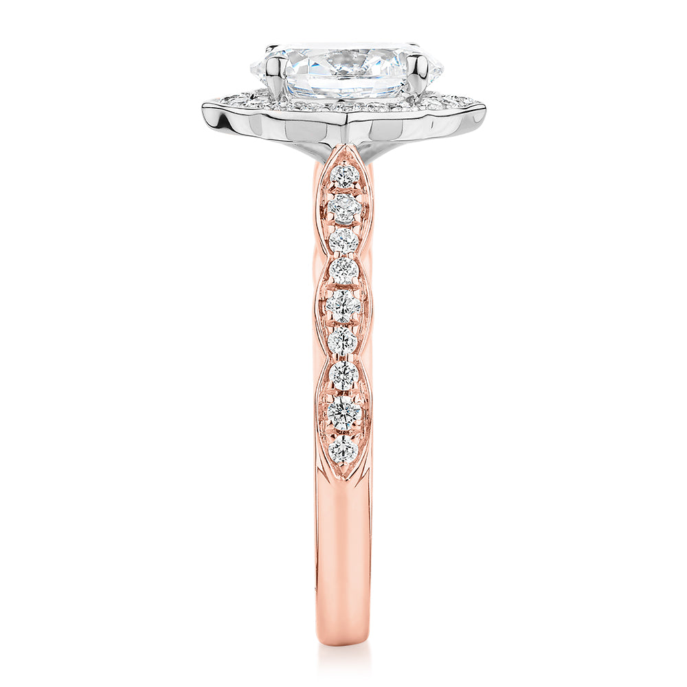 Oval halo engagement ring with 1.55 carats* of diamond simulants in 14 carat rose and white gold