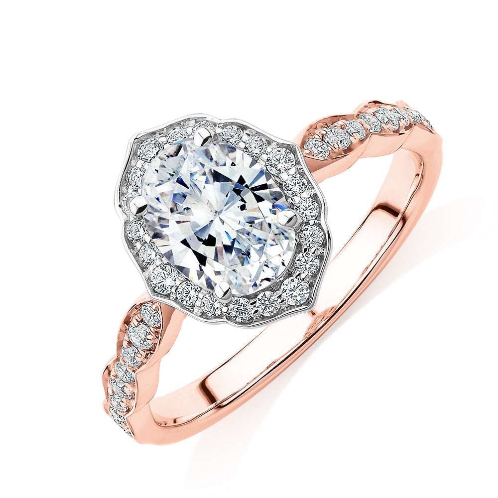 Oval halo engagement ring with 1.55 carats* of diamond simulants in 14 carat rose and white gold