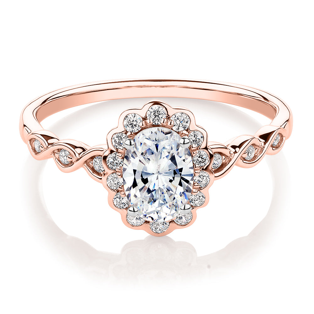 Oval and Round Brilliant halo engagement ring with 0.97 carats* of diamond simulants in 10 carat rose gold