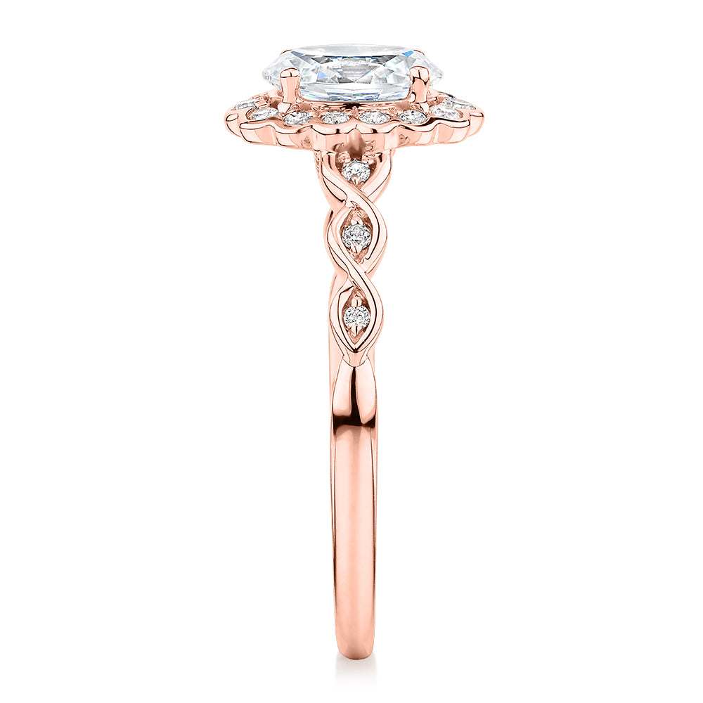Oval and Round Brilliant halo engagement ring with 0.97 carats* of diamond simulants in 10 carat rose gold