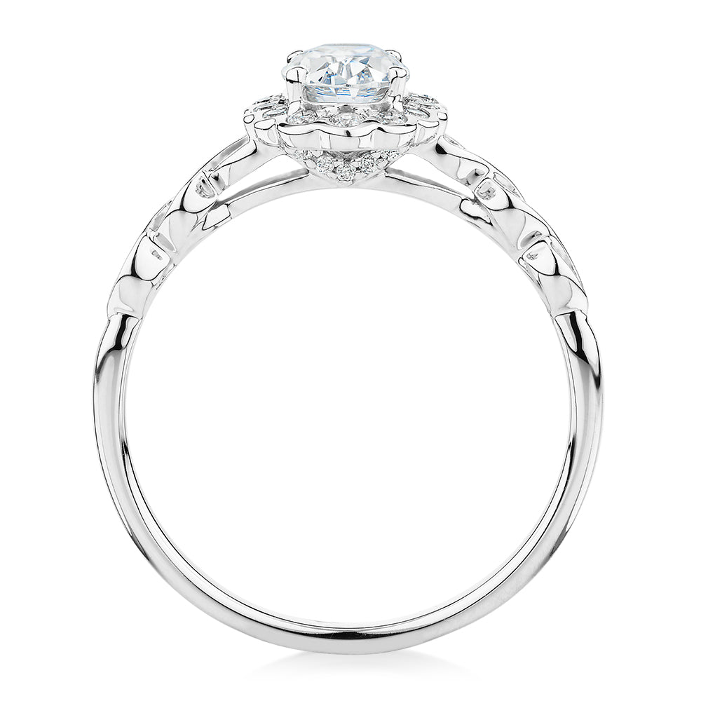 Oval and Round Brilliant halo engagement ring with 0.97 carats* of diamond simulants in 10 carat white gold