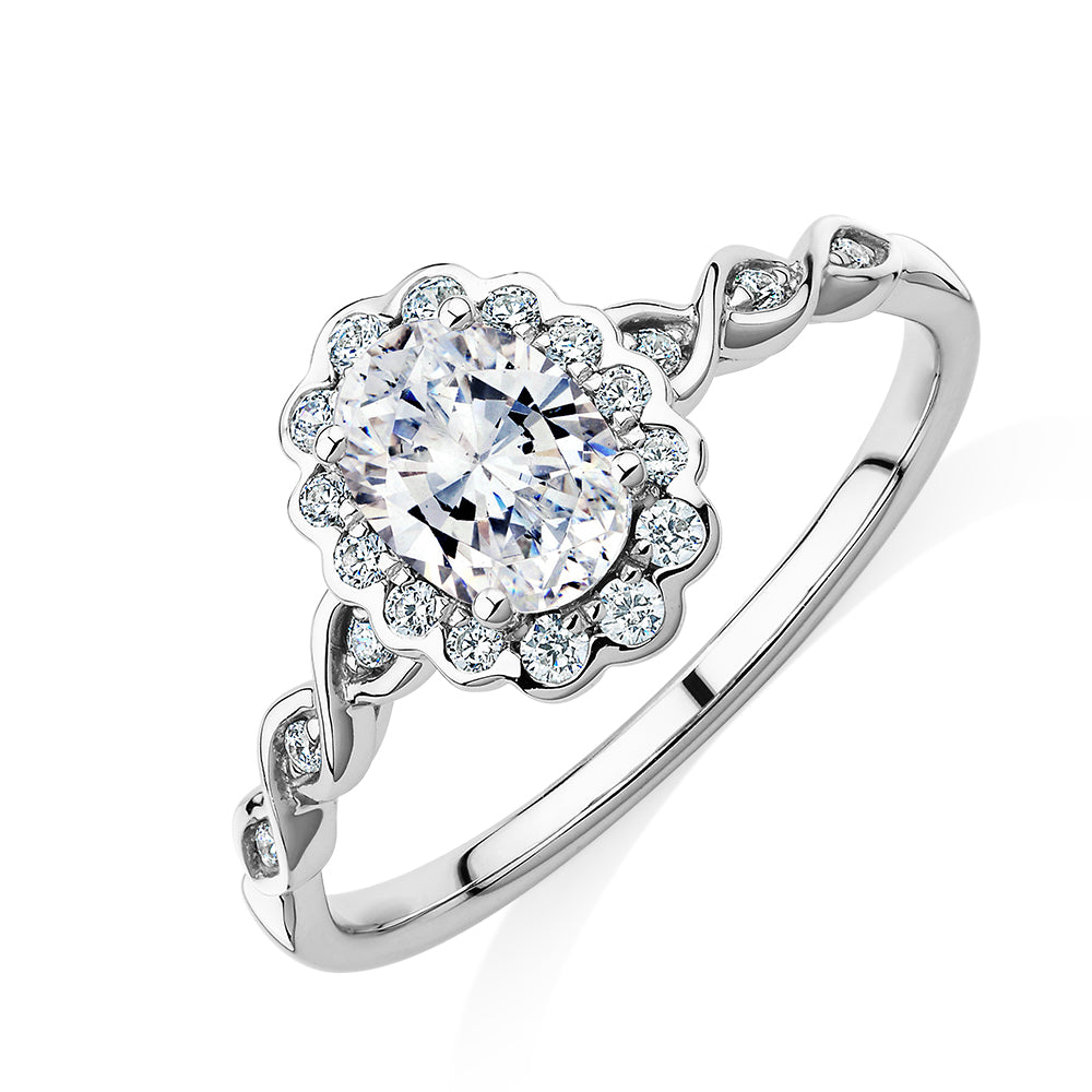 Oval and Round Brilliant halo engagement ring with 0.97 carats* of diamond simulants in 10 carat white gold