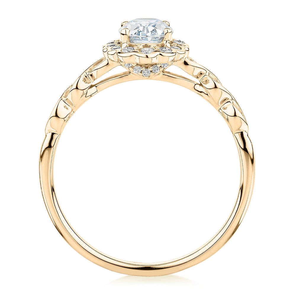 Oval and Round Brilliant halo engagement ring with 0.97 carats* of diamond simulants in 10 carat yellow gold