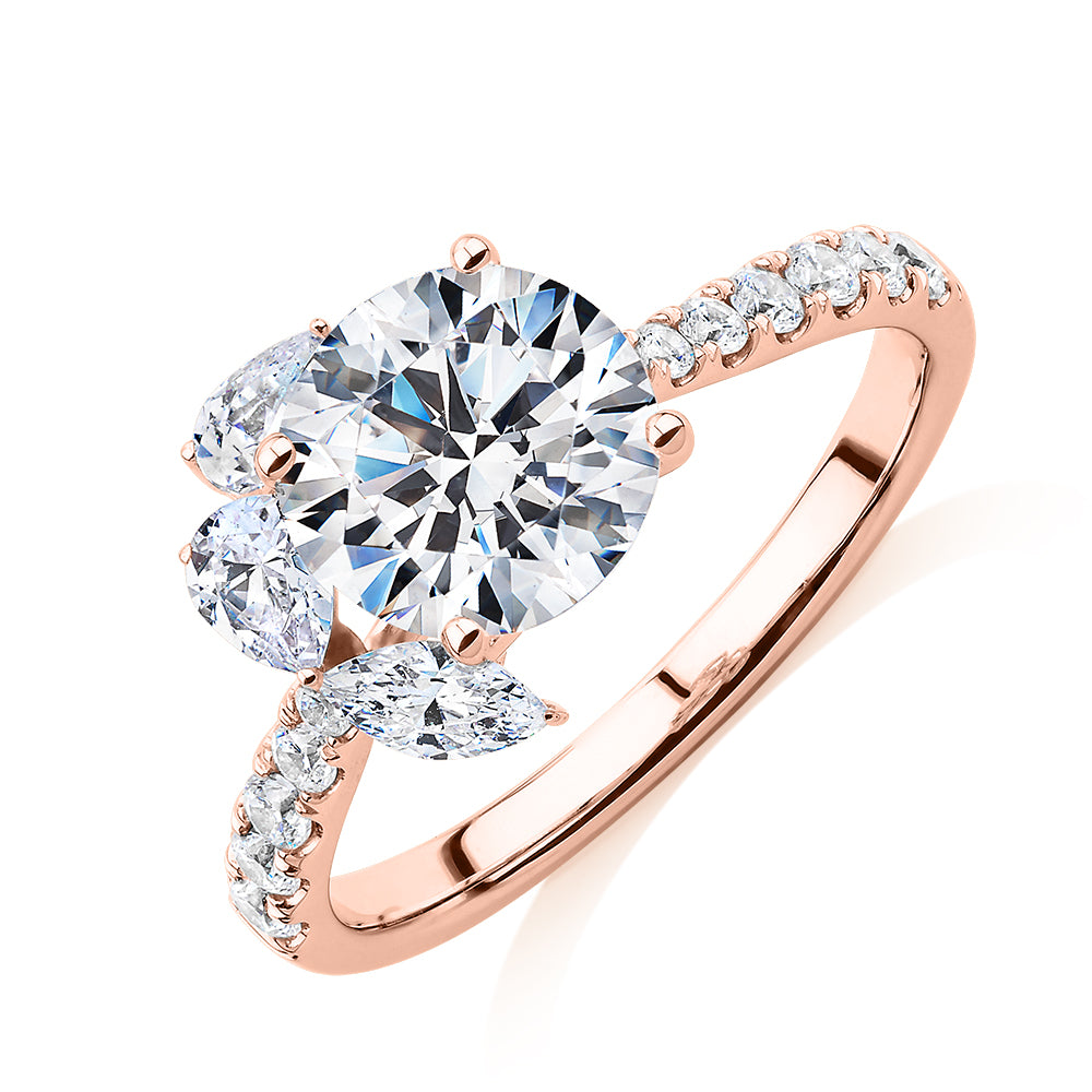 Round Brilliant and Marquise shouldered engagement ring with 2.78 carats* of diamond simulants in 14 carat rose gold
