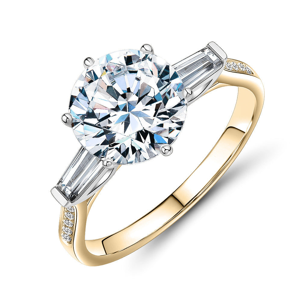 Round Brilliant and Baguette shouldered engagement ring with 3.23 carats* of diamond simulants in 14 carat yellow and white gold