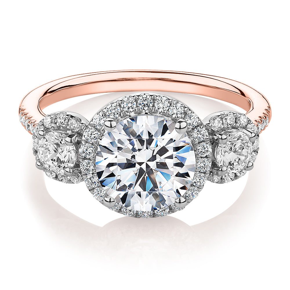 Three stone ring with 2.68 carats* of diamond simulants in 10 carat rose and white gold