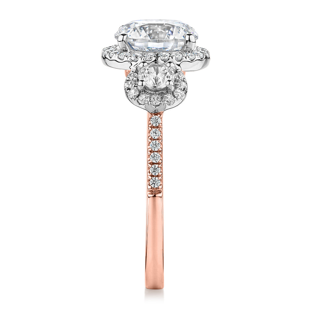 Three stone ring with 2.68 carats* of diamond simulants in 10 carat rose and white gold