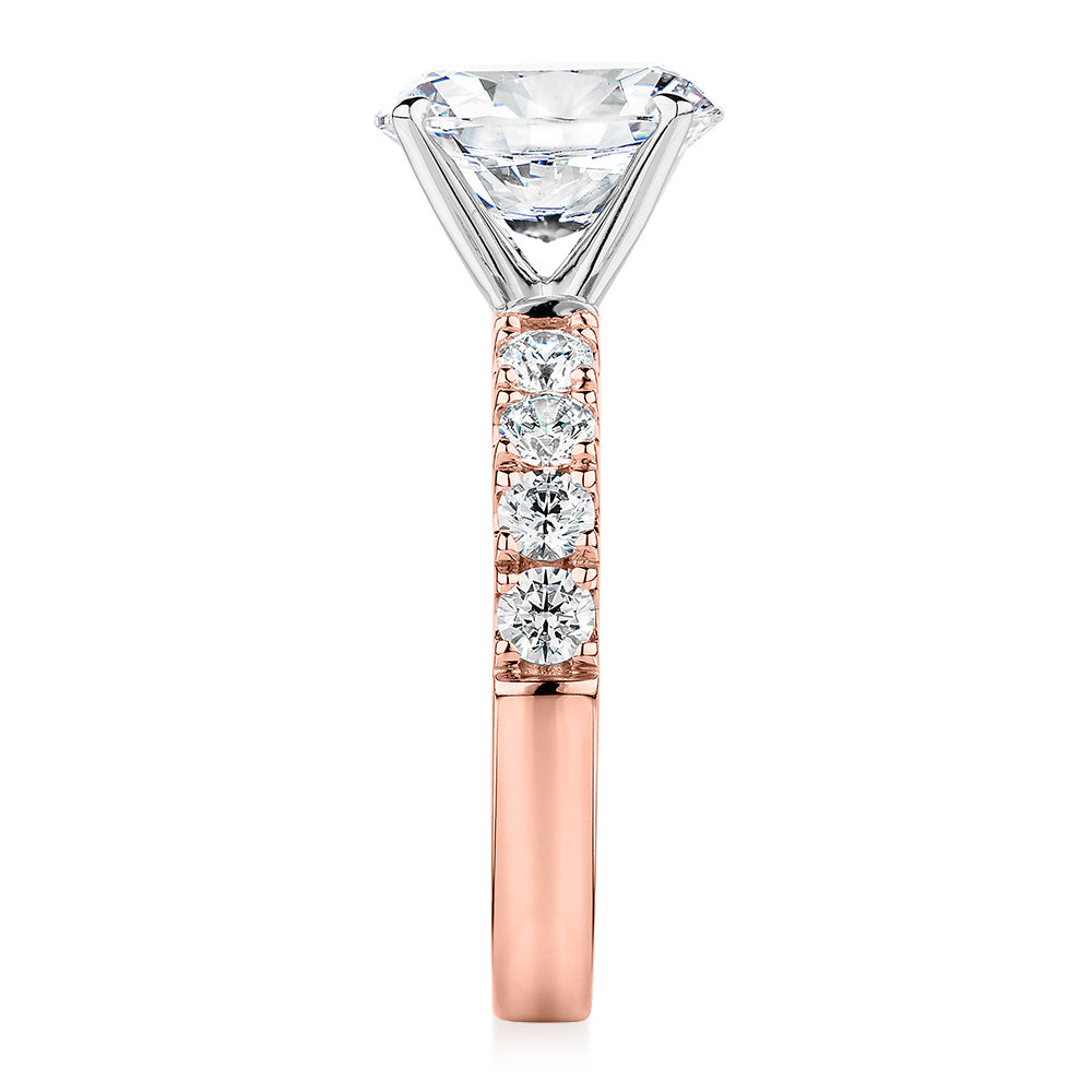 Oval shouldered engagement ring with 3.18 carats* of diamond simulants in 14 carat rose and white gold