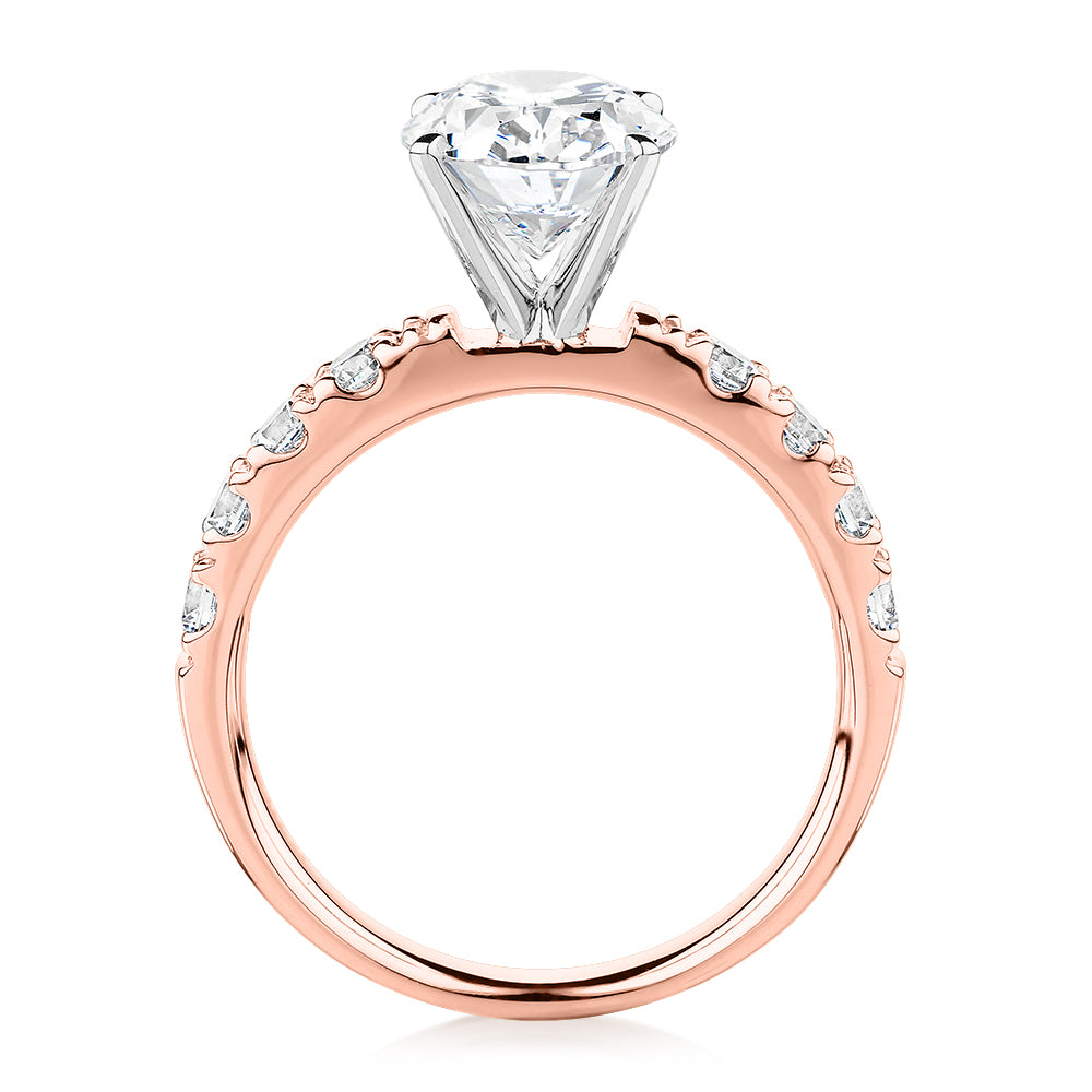 Oval shouldered engagement ring with 3.18 carats* of diamond simulants in 14 carat rose and white gold