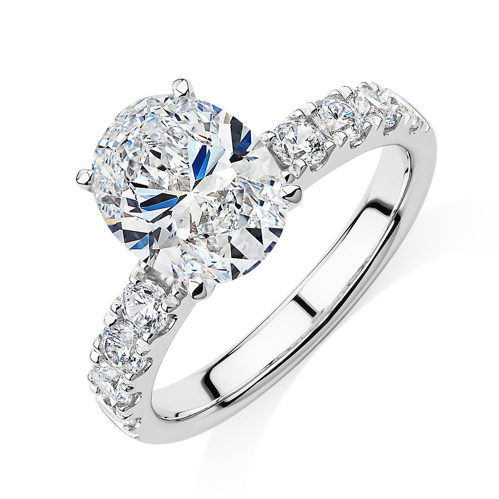 Oval shouldered engagement ring with 3.18 carats* of diamond simulants in 14 carat white gold