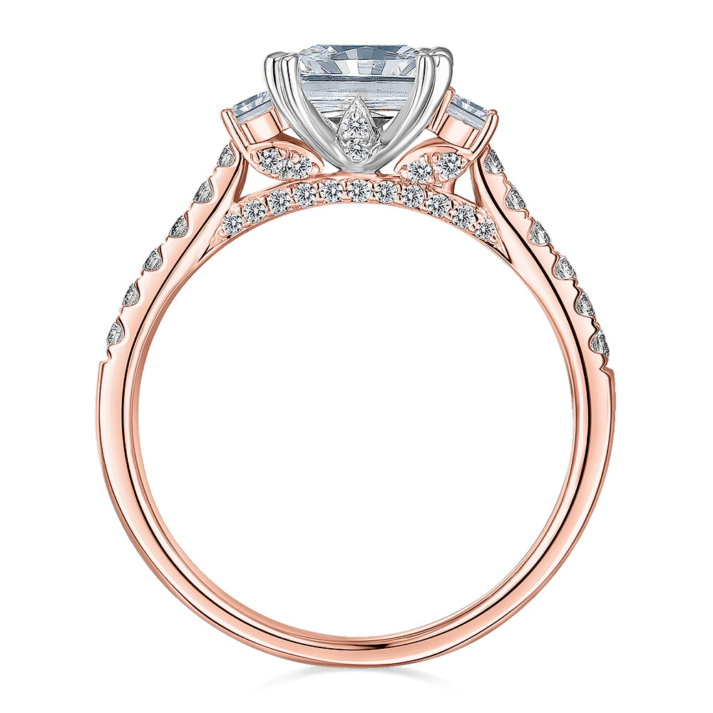 Three stone ring with 2.2 carats* of diamond simulants in 14 carat rose and white gold