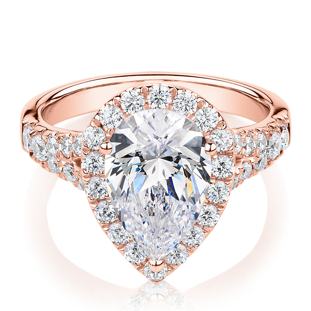 Pear and Round Brilliant halo engagement ring with 3.81 carats* of diamond simulants in 10 carat rose gold
