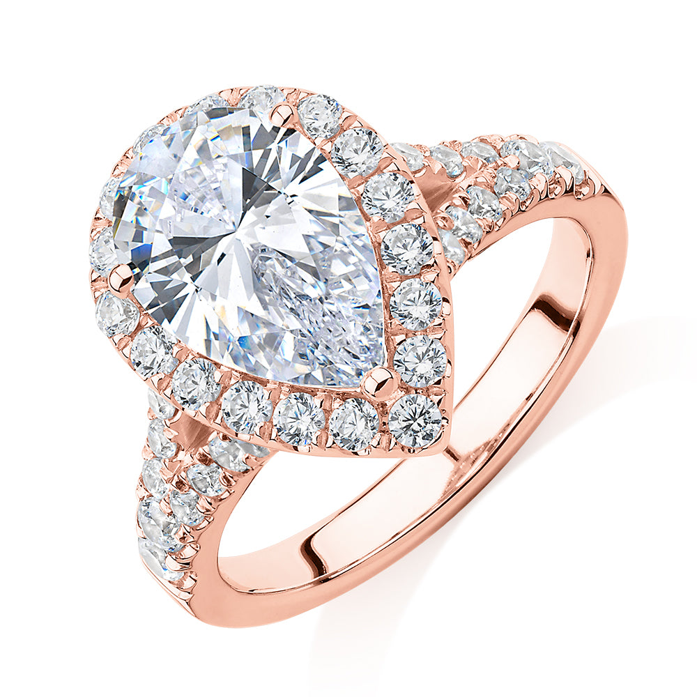 Pear and Round Brilliant halo engagement ring with 3.81 carats* of diamond simulants in 10 carat rose gold