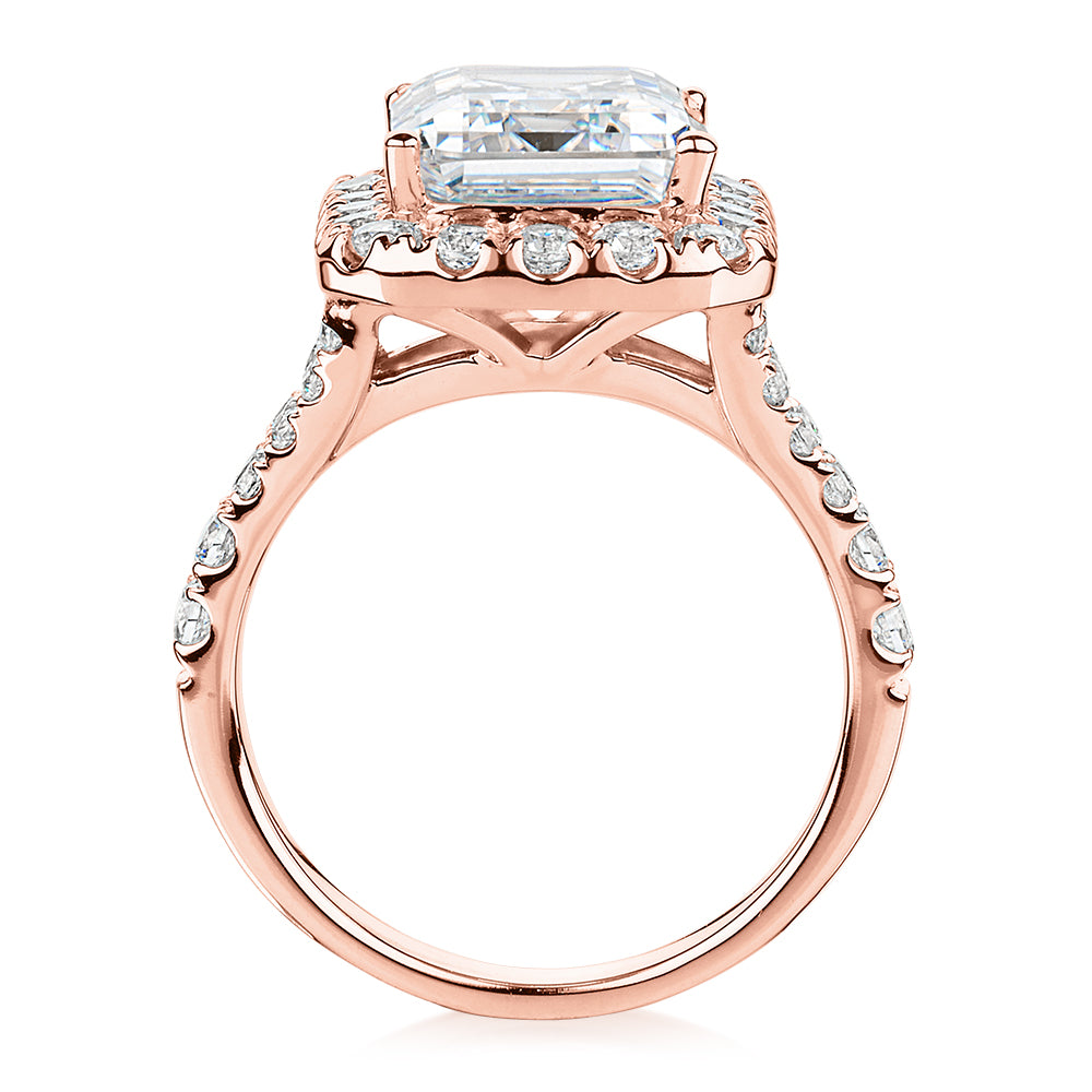 Emerald Cut and Round Brilliant halo engagement ring with 5.95 carats* of diamond simulants in 10 carat rose gold