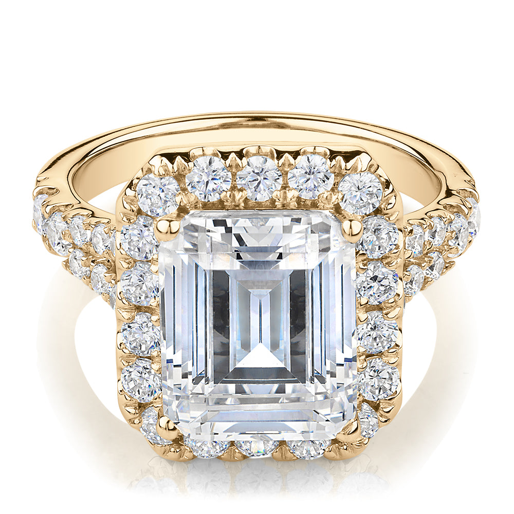 Emerald Cut and Round Brilliant halo engagement ring with 5.95 carats* of diamond simulants in 10 carat yellow gold