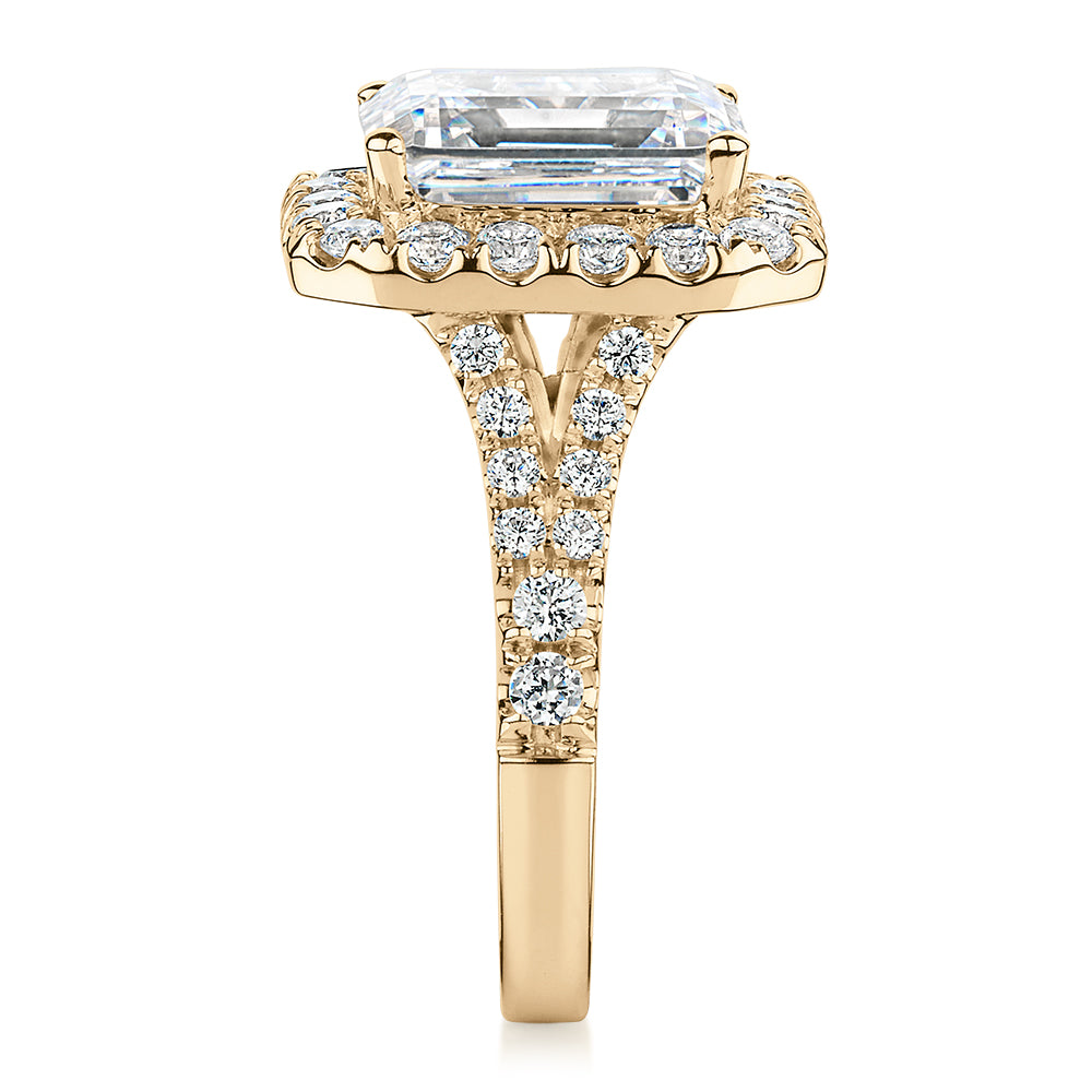 Emerald Cut and Round Brilliant halo engagement ring with 5.95 carats* of diamond simulants in 10 carat yellow gold
