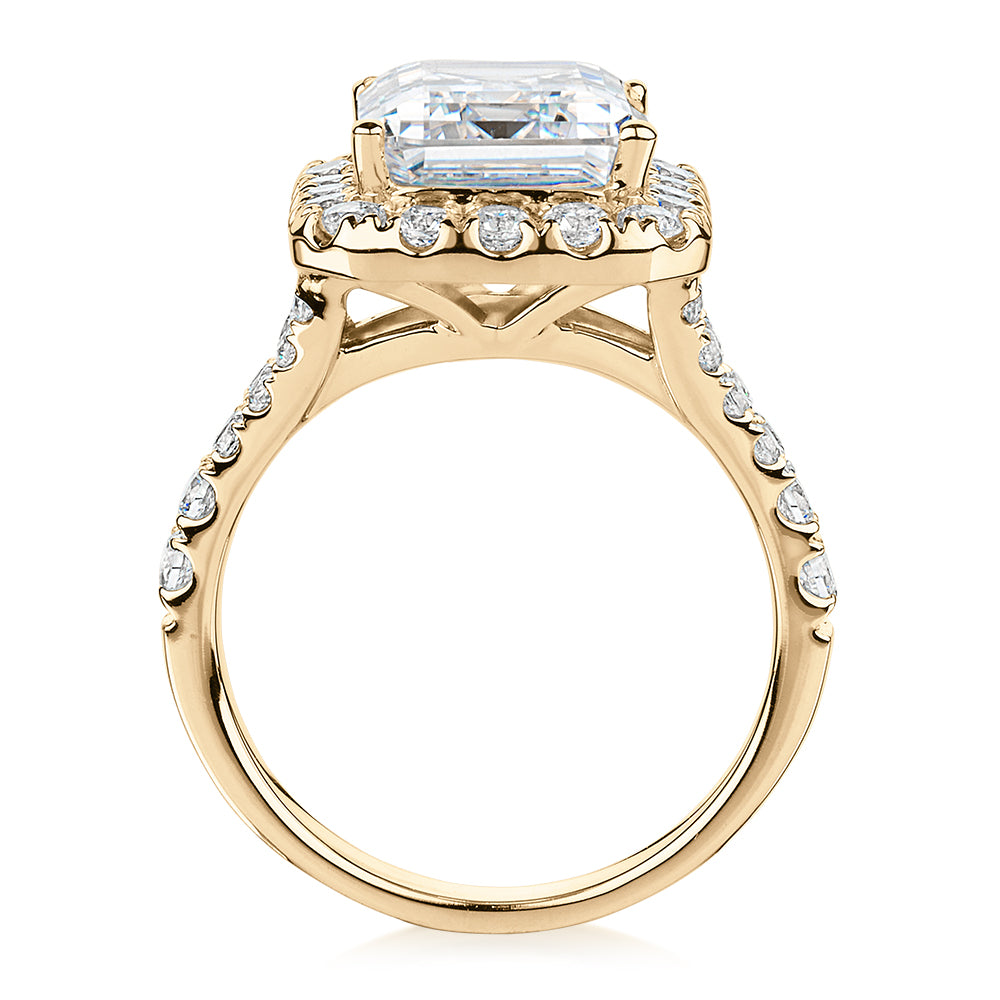 Emerald Cut and Round Brilliant halo engagement ring with 5.95 carats* of diamond simulants in 10 carat yellow gold