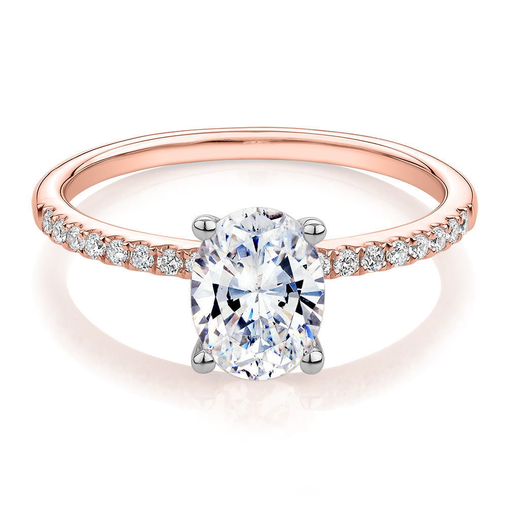 Oval and Round Brilliant shouldered engagement ring with 1.35 carats* of diamond simulants in 14 carat rose and white gold