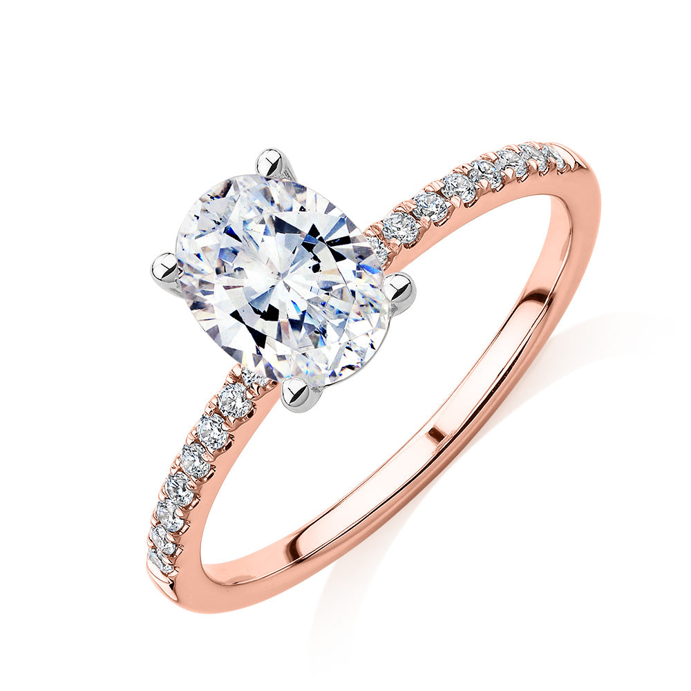 Oval and Round Brilliant shouldered engagement ring with 1.35 carats* of diamond simulants in 14 carat rose and white gold