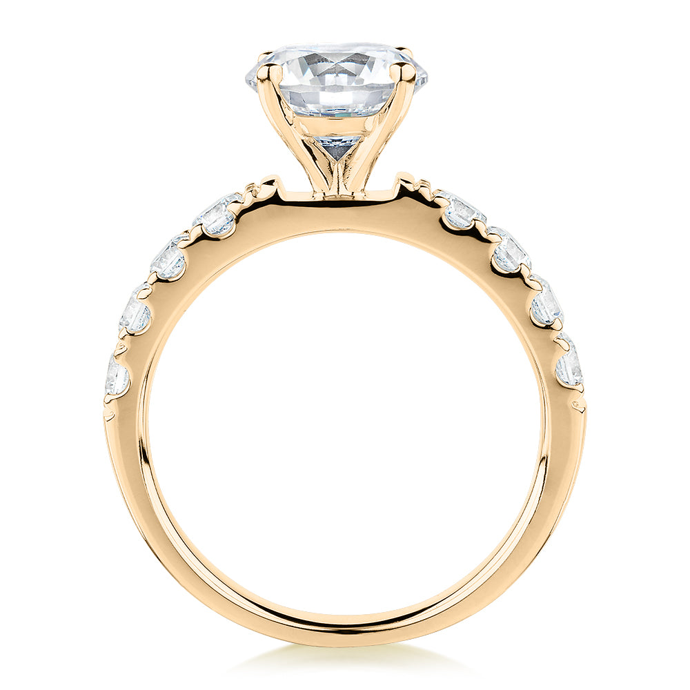 Round Brilliant shouldered engagement ring with 2.68 carats* of diamond simulants in 14 carat yellow gold