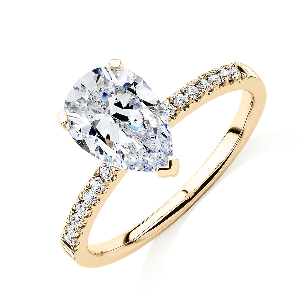 Pear and Round Brilliant shouldered engagement ring with 1.88 carats* of diamond simulants in 14 carat yellow gold