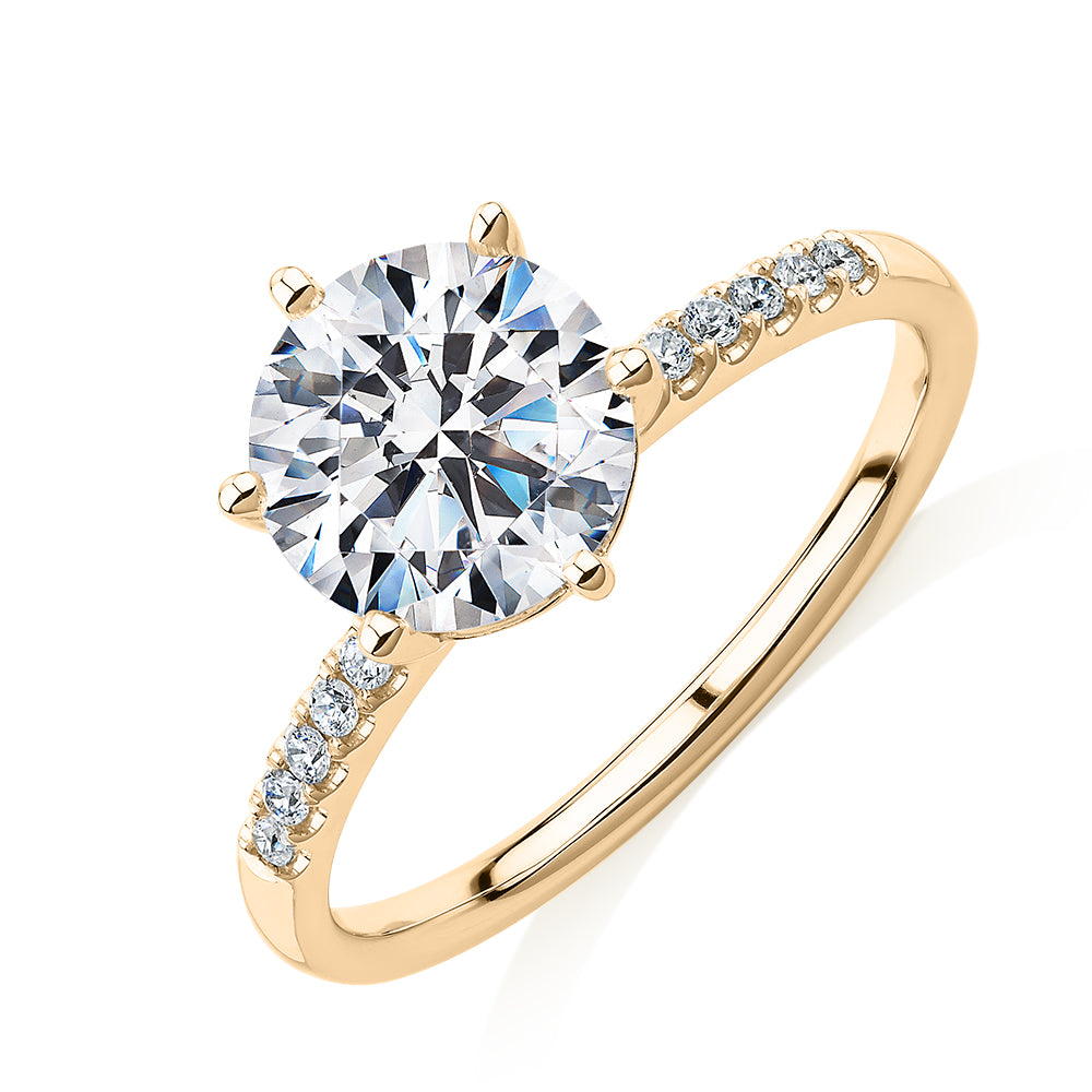 Round Brilliant shouldered engagement ring with 2.12 carats* of diamond simulants in 14 carat yellow gold